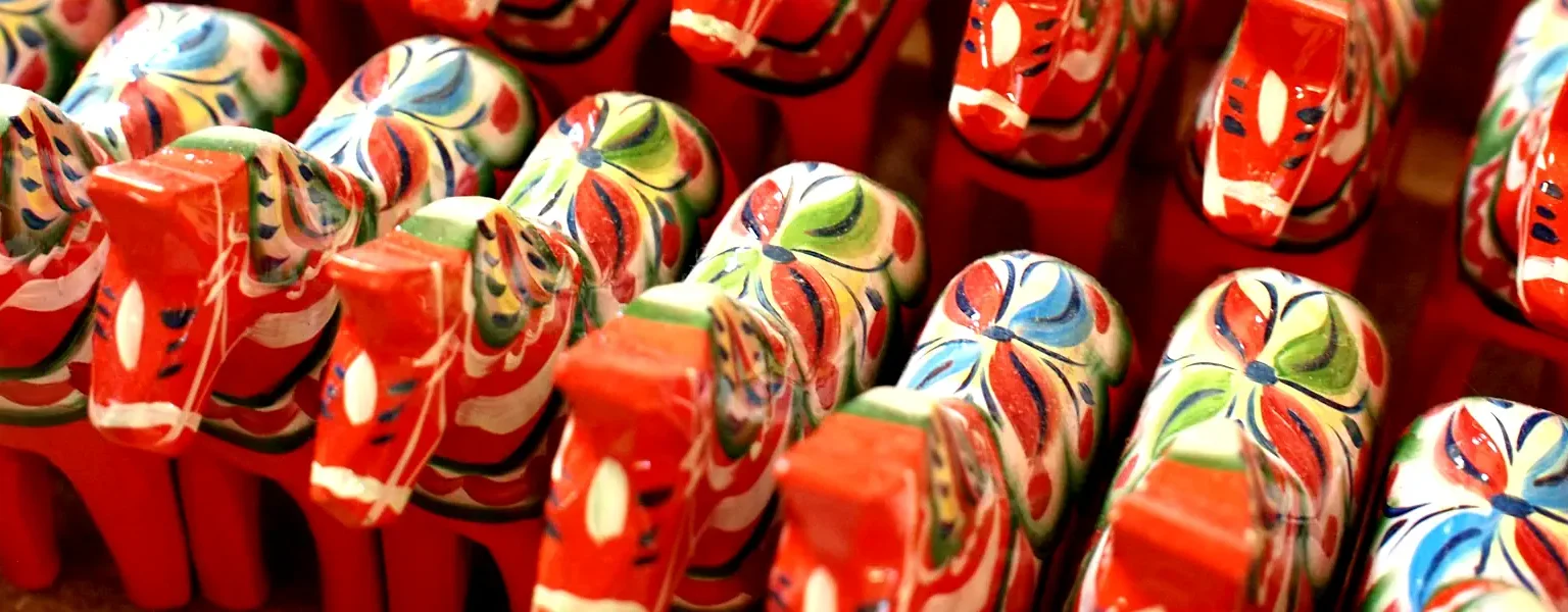 Dala horses arranged in a row, poised to journey across Sweden or even beyond. Photo: Nick Sieger (CC BY-SA 2.0)