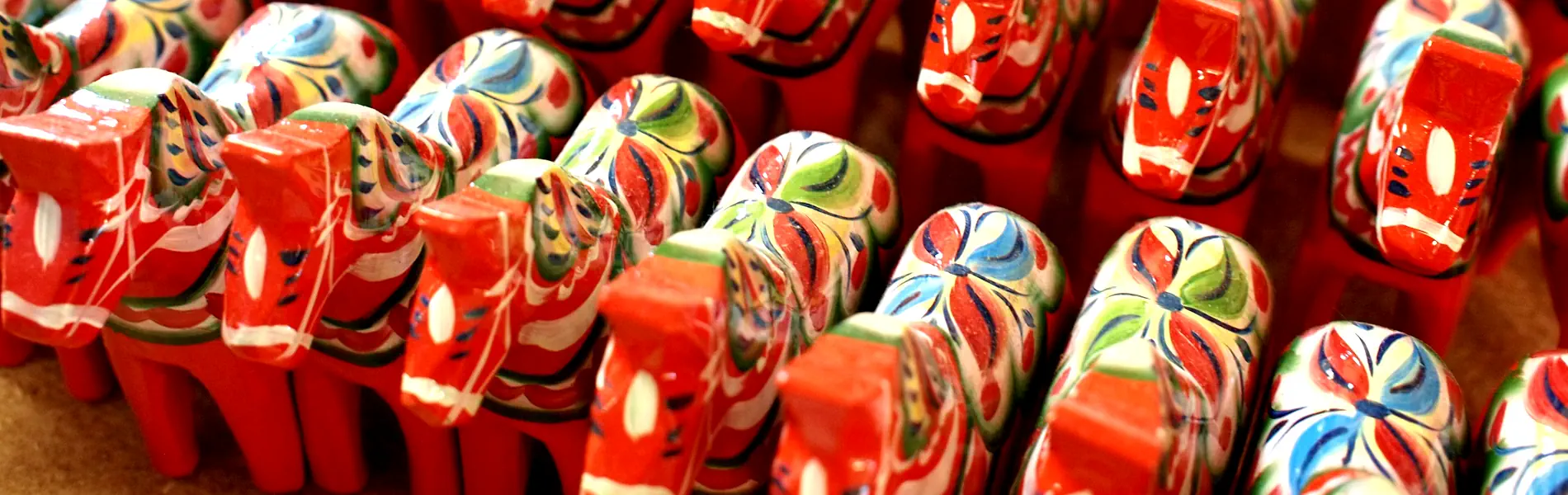 Dala horses arranged in a row, poised to journey across Sweden or even beyond. Photo: Nick Sieger (CC BY-SA 2.0)