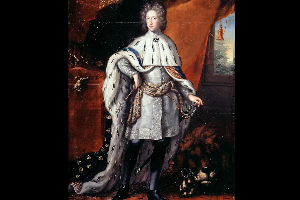 Karl XII in his coronation robes in 1697, surrounded by symbols of royal power and absolutism — the regalia to the left, and a reclining lion to the right. Photo: Public domain