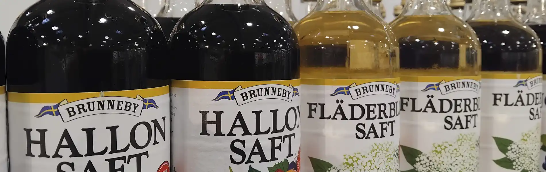 Bottles of saft (raspberry and elderflower) on a shelf in a typical Swedish grocery store. © StockholmMuseum.com